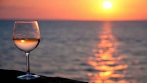 Glass of rosé wine at sunset 